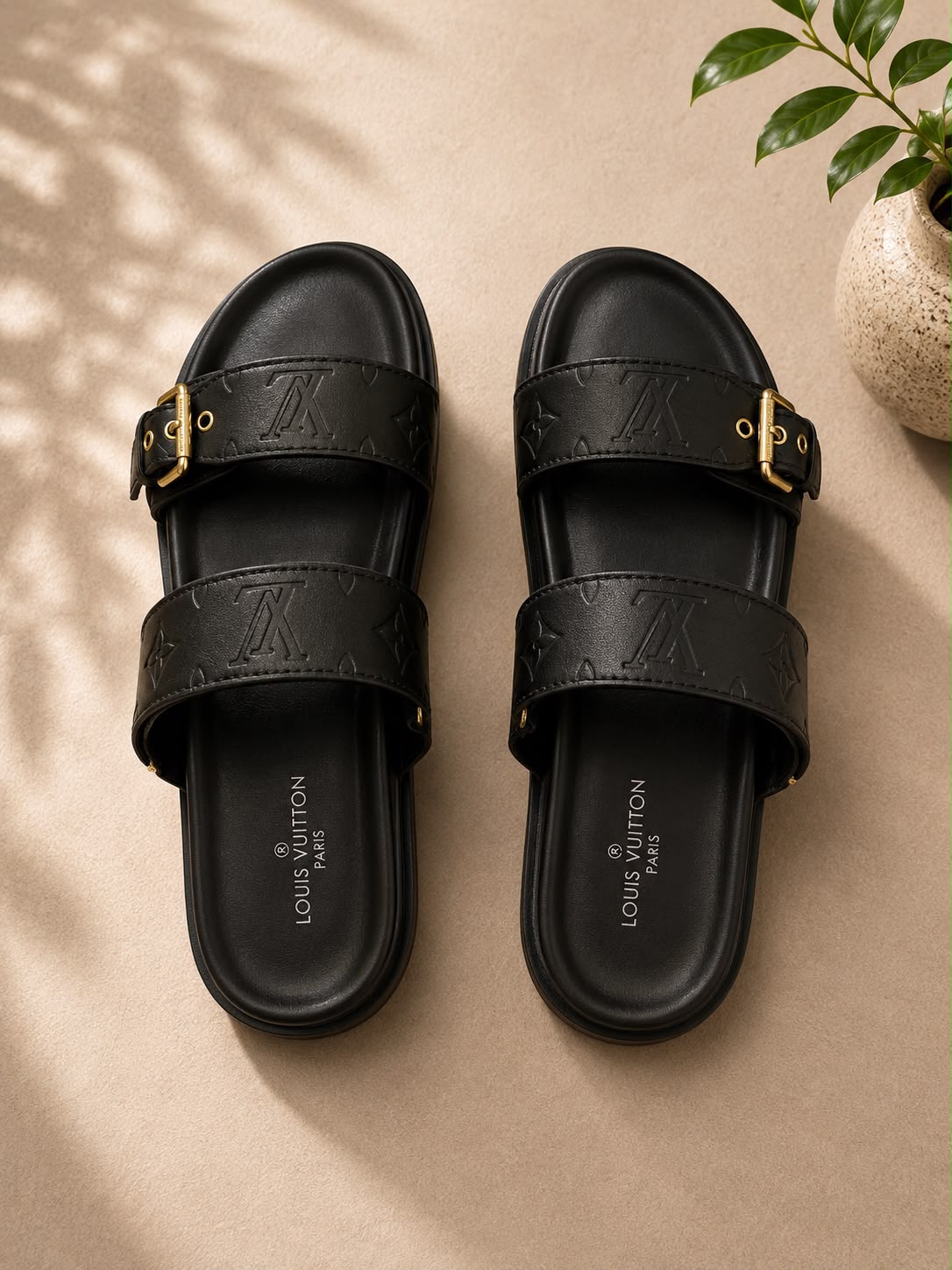 Louis Vuitton Bom Dia Flat Mule in black monogram embossed leather with gold buckles