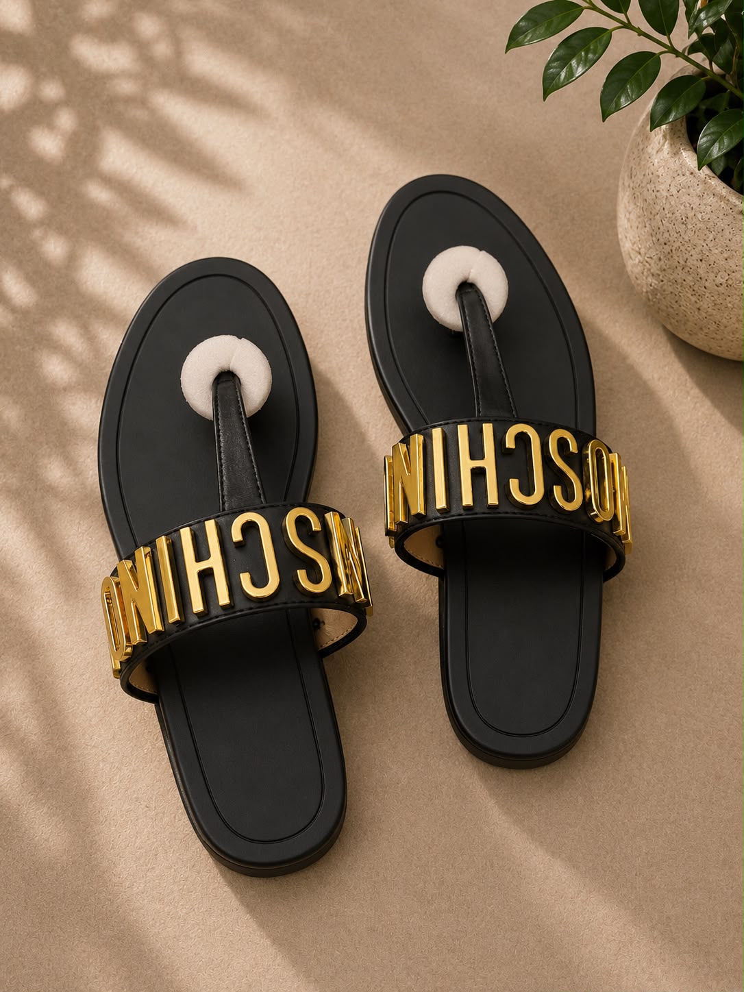 Moschino logo thong sandal in black leather with gold 3D letter hardware